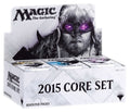 Closed cardboard booster box with colorful fantasy card art on the lid, stacked on a neutral surface